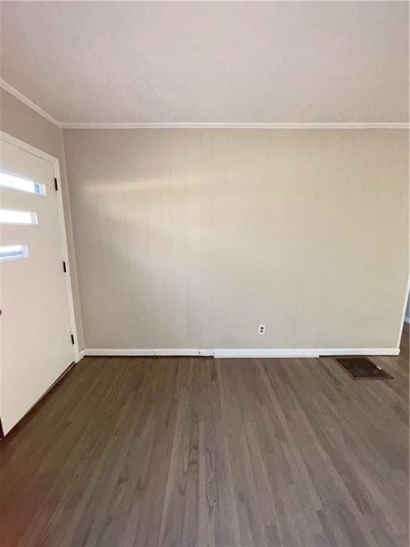 foyer with dark hardwood / wood-style flooring and crown molding