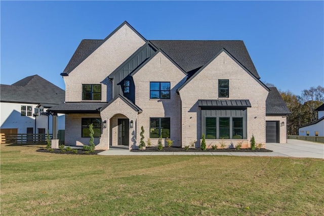 view of front of property featuring a front yard and a garage