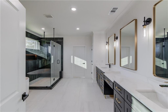 bathroom with tile patterned flooring, vanity, and walk in shower