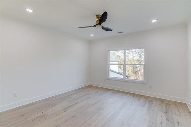 spare room with light hardwood / wood-style floors and ceiling fan