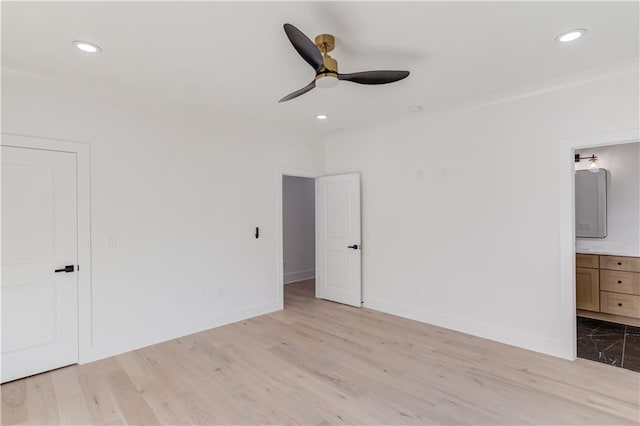 unfurnished bedroom with connected bathroom, light hardwood / wood-style flooring, and ceiling fan