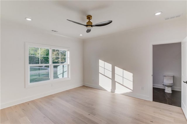 spare room featuring ceiling fan and light hardwood / wood-style flooring