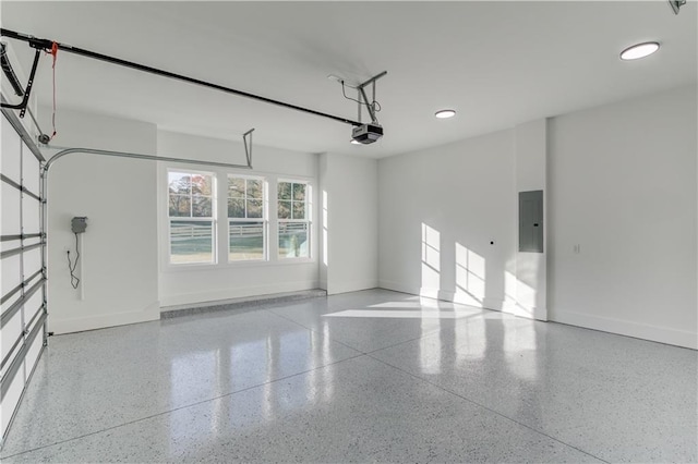 garage featuring electric panel and a garage door opener