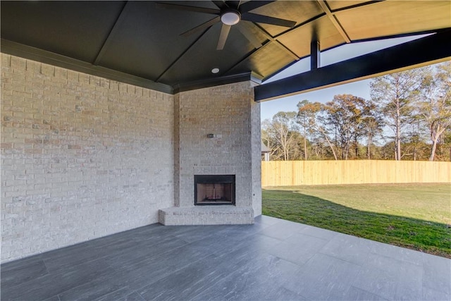 view of patio / terrace with an outdoor brick fireplace and ceiling fan