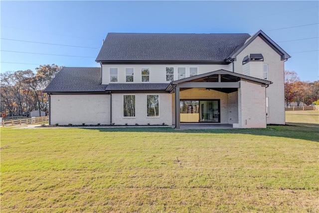 rear view of house featuring a lawn