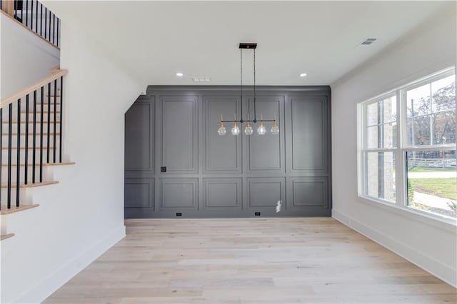 unfurnished dining area featuring light hardwood / wood-style floors and a healthy amount of sunlight