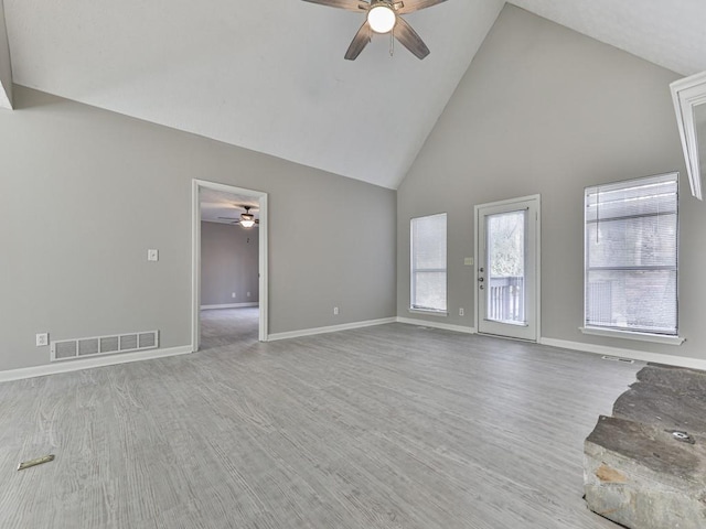 unfurnished living room featuring wood-type flooring, high vaulted ceiling, and ceiling fan