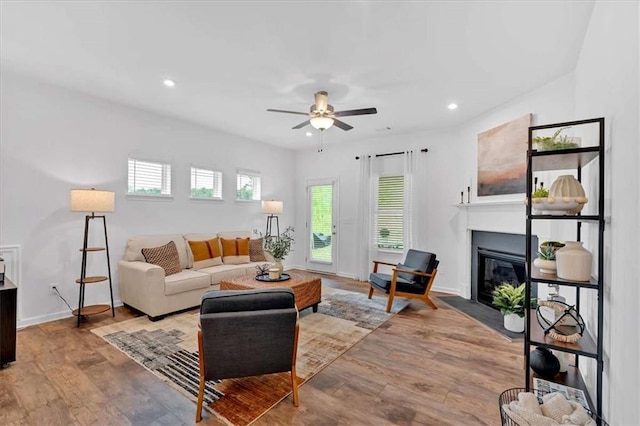 2703 Jordan Ln, Lithia Springs, GA 30122 - living room with a fireplace with flush hearth, ceiling fan, recessed lighting, and wood finished floors