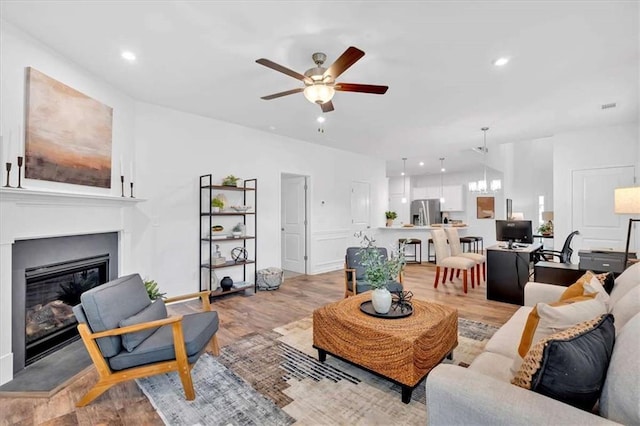2703 Jordan Ln, Lithia Springs, GA 30122 - living area featuring ceiling fan, a glass covered fireplace, light wood-style floors, and recessed lighting