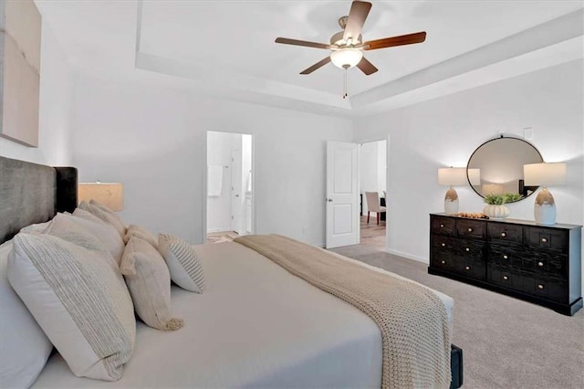 2703 Jordan Ln, Lithia Springs, GA 30122 - bedroom with carpet floors, a raised ceiling, ensuite bath, and a ceiling fan