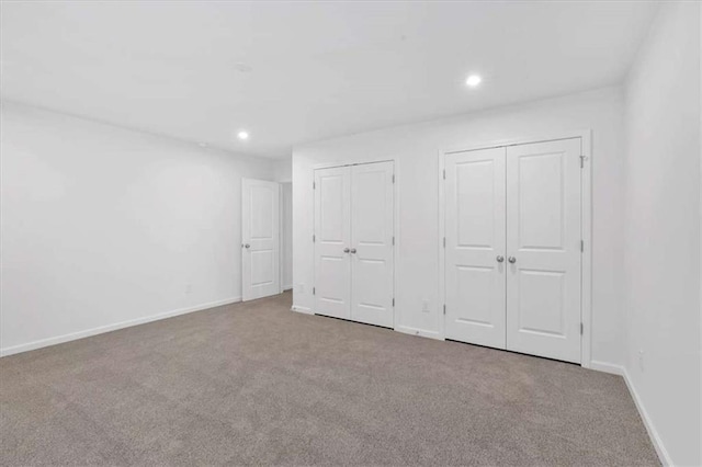 2703 Jordan Ln, Lithia Springs, GA 30122 - unfurnished bedroom with multiple closets, carpet, and recessed lighting