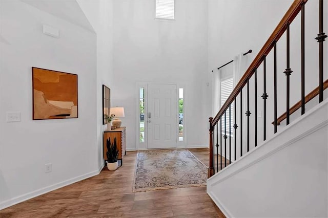 2703 Jordan Ln, Lithia Springs, GA 30122 - entrance foyer with healthy amount of natural light, a high ceiling, wood finished floors, and stairway