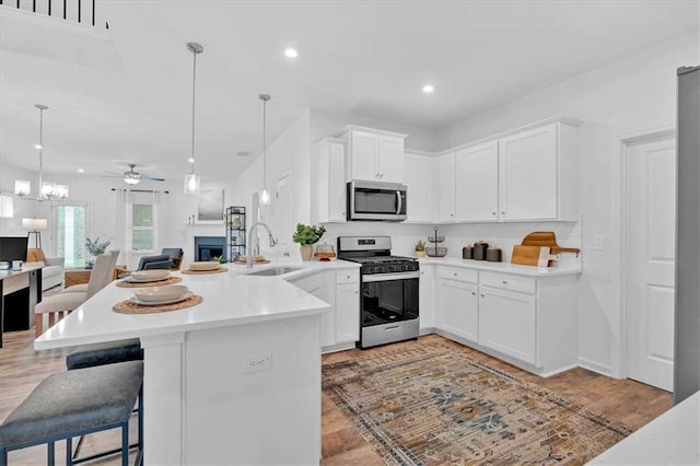 2703 Jordan Ln, Lithia Springs, GA 30122 - kitchen with stainless steel appliances, a peninsula, open floor plan, light countertops, and recessed lighting