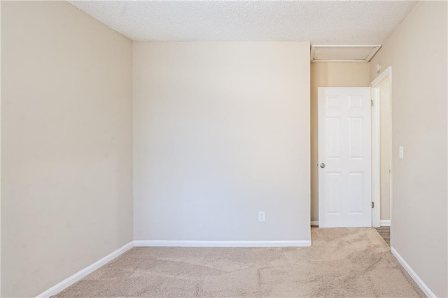 unfurnished room featuring a textured ceiling and carpet floors