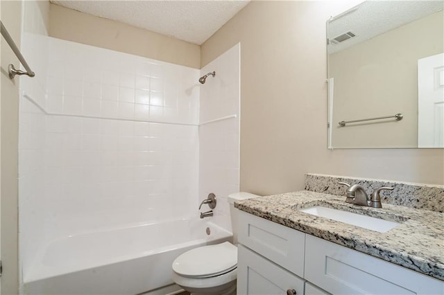 full bathroom featuring a textured ceiling, toilet, vanity, and shower / washtub combination