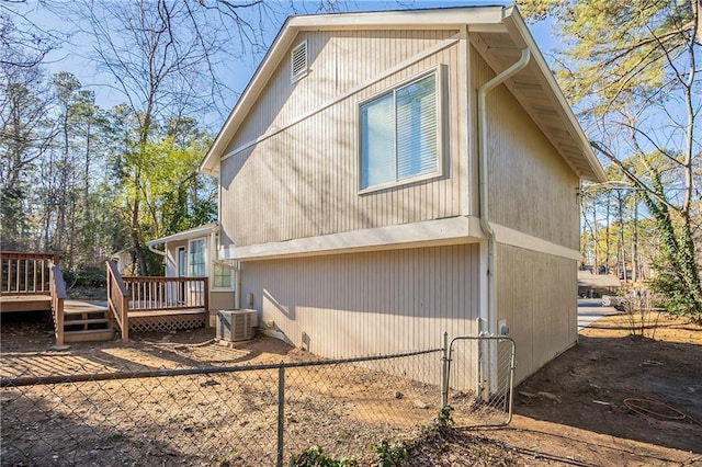 view of home's exterior featuring central AC and a deck