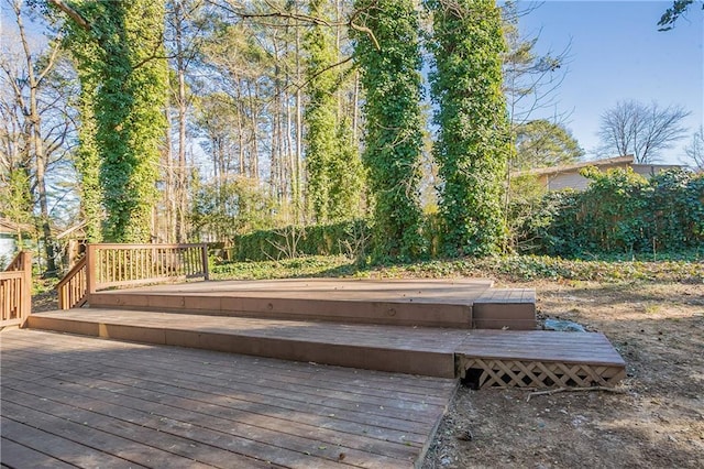 wooden deck featuring a hot tub