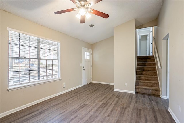 entrance foyer with lofted ceiling, ceiling fan, and dark hardwood / wood-style flooring