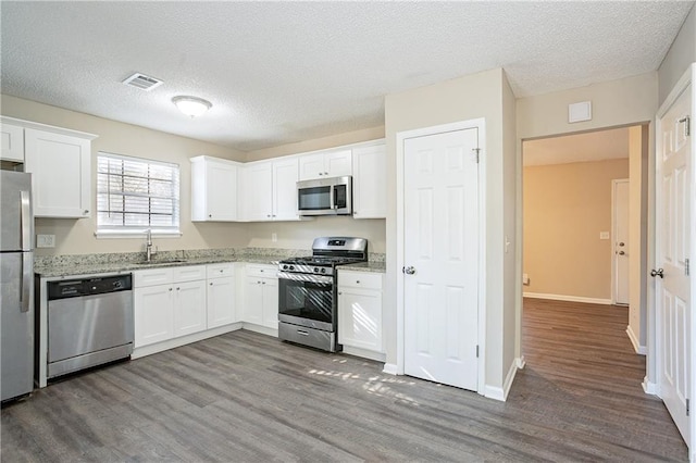 kitchen featuring sink, white cabinetry, and appliances with stainless steel finishes