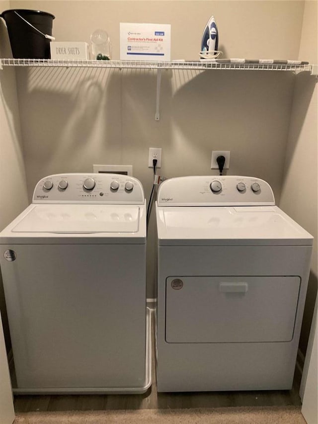 clothes washing area with washing machine and dryer