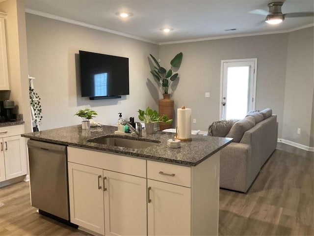 kitchen featuring dark hardwood / wood-style floors, dishwasher, sink, an island with sink, and dark stone counters