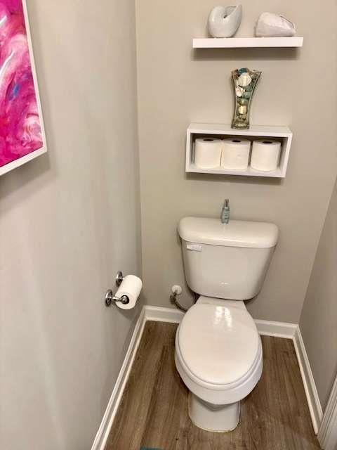 bathroom featuring toilet and hardwood / wood-style flooring