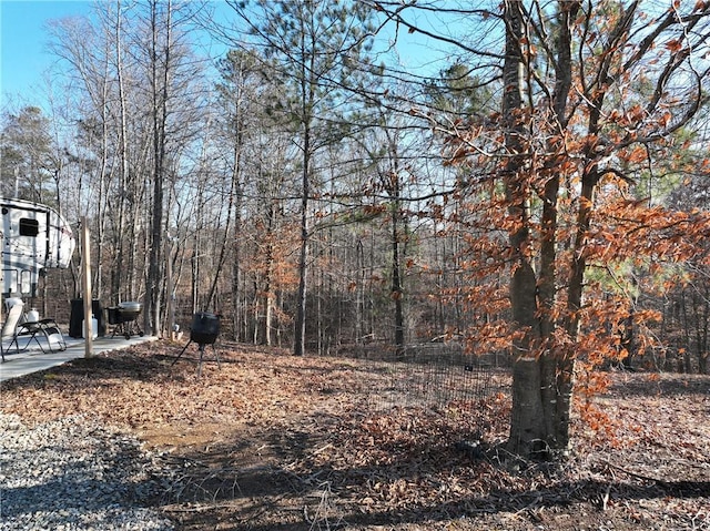 view of yard featuring a patio and a forest view