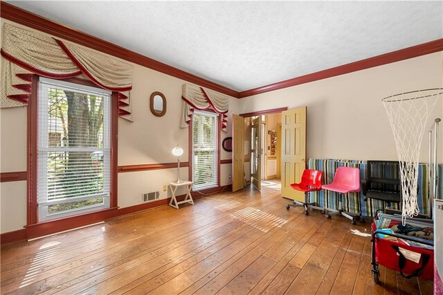 6048 Kings Mountain Way, Tucker, GA 30087 - sitting room with baseboards, a textured ceiling, crown molding, visible vents, and hardwood / wood-style floors