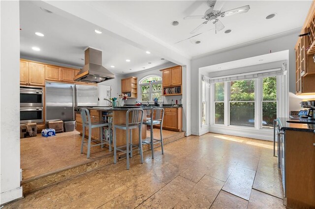 6048 Kings Mountain Way, Tucker, GA 30087 - kitchen featuring a kitchen bar, open shelves, ornamental molding, island exhaust hood, and dark countertops