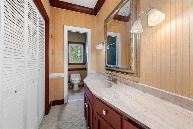 6048 Kings Mountain Way, Tucker, GA 30087 - bathroom with a closet, ornamental molding, toilet, vanity, and wood walls