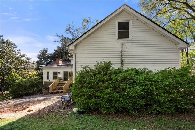 6048 Kings Mountain Way, Tucker, GA 30087 - view of side of home featuring stairs, a wooden deck, and a chimney
