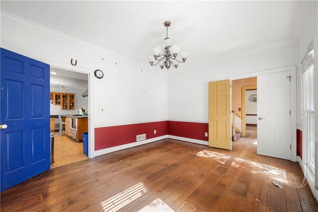 6048 Kings Mountain Way, Tucker, GA 30087 - interior space with baseboards, a chandelier, crown molding, visible vents, and wood-type flooring