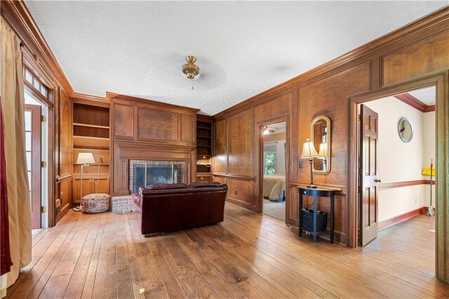 6048 Kings Mountain Way, Tucker, GA 30087 - living room with a ceiling fan, ornamental molding, a brick fireplace, baseboards, and hardwood / wood-style flooring