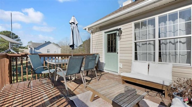 deck with outdoor dining area