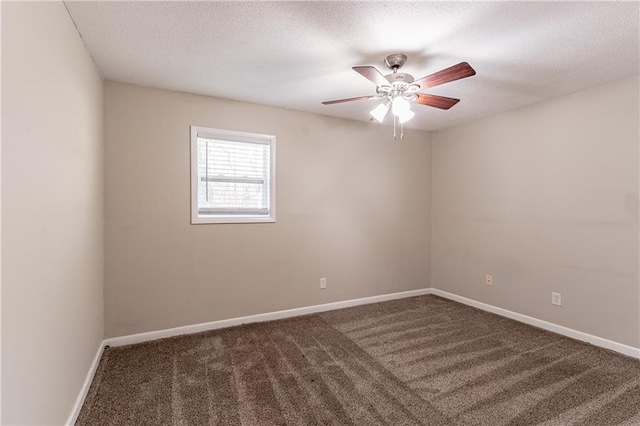 unfurnished room with ceiling fan, a textured ceiling, and dark colored carpet