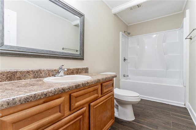 full bathroom with wood-type flooring, toilet, shower / tub combination, vanity, and ornamental molding