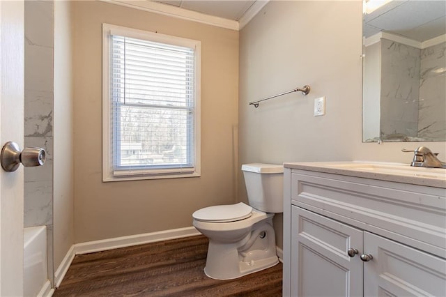 full bathroom featuring vanity, bathing tub / shower combination, hardwood / wood-style flooring, toilet, and ornamental molding