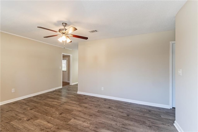 empty room with ceiling fan and dark wood-type flooring