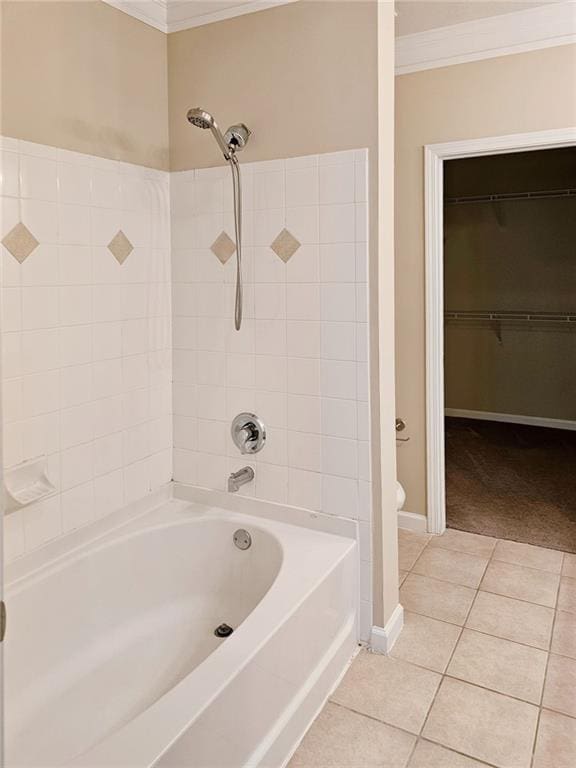 bathroom with toilet, tiled shower / bath combo, tile patterned floors, and ornamental molding