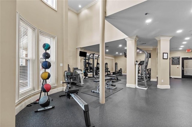 gym featuring decorative columns and crown molding