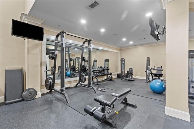 exercise room featuring crown molding