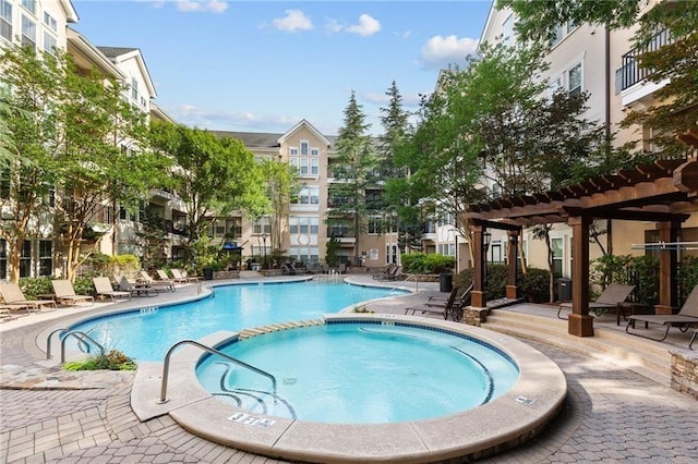 view of swimming pool with a community hot tub, a patio, and a pergola