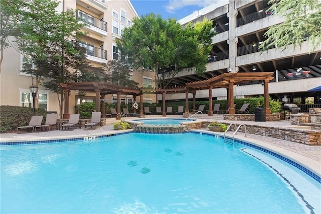 view of pool with a community hot tub, a patio area, and a pergola