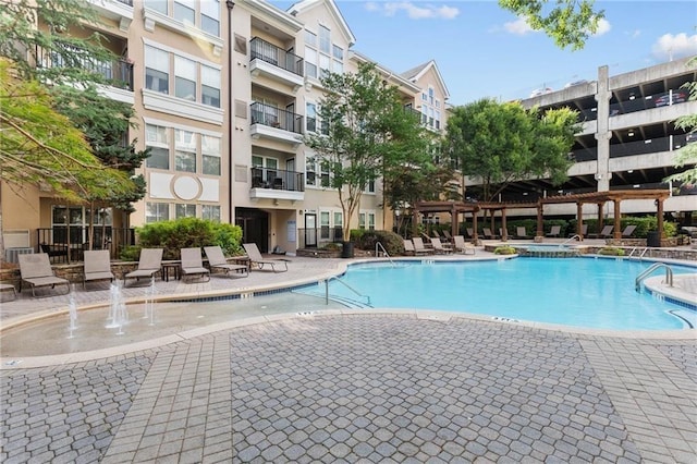 view of swimming pool with a patio area and pool water feature