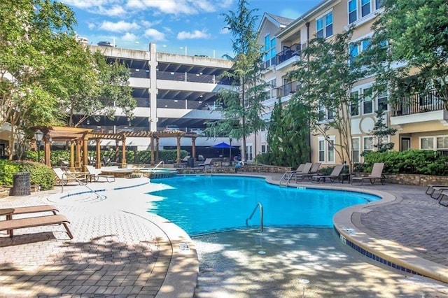 view of swimming pool with a pergola and a patio