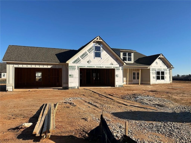 property in mid-construction featuring a garage and dirt driveway