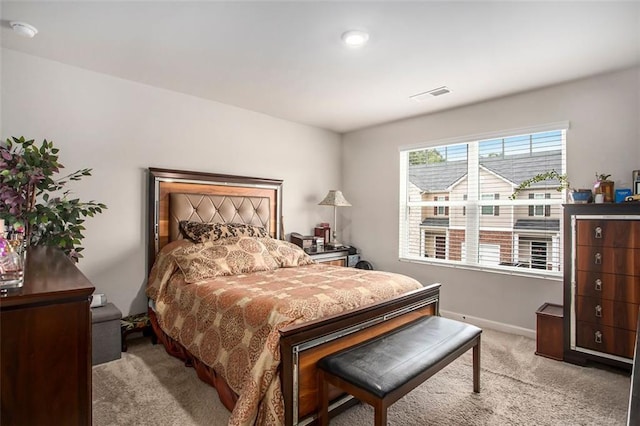 bedroom featuring light carpet