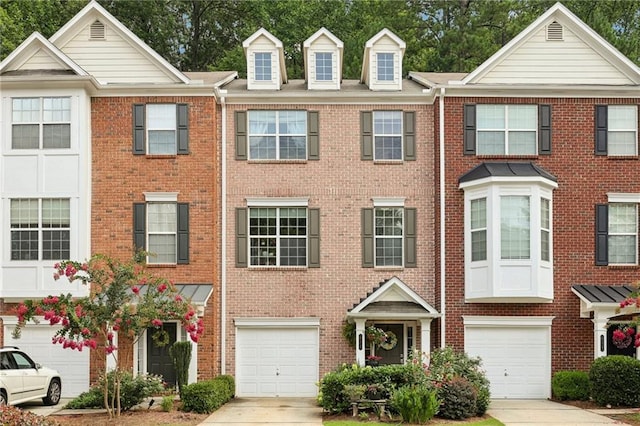 townhome / multi-family property featuring a garage