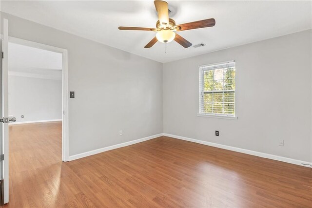 spare room with ceiling fan and light hardwood / wood-style flooring