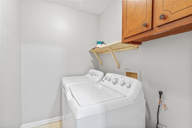 laundry area featuring cabinets and washing machine and clothes dryer